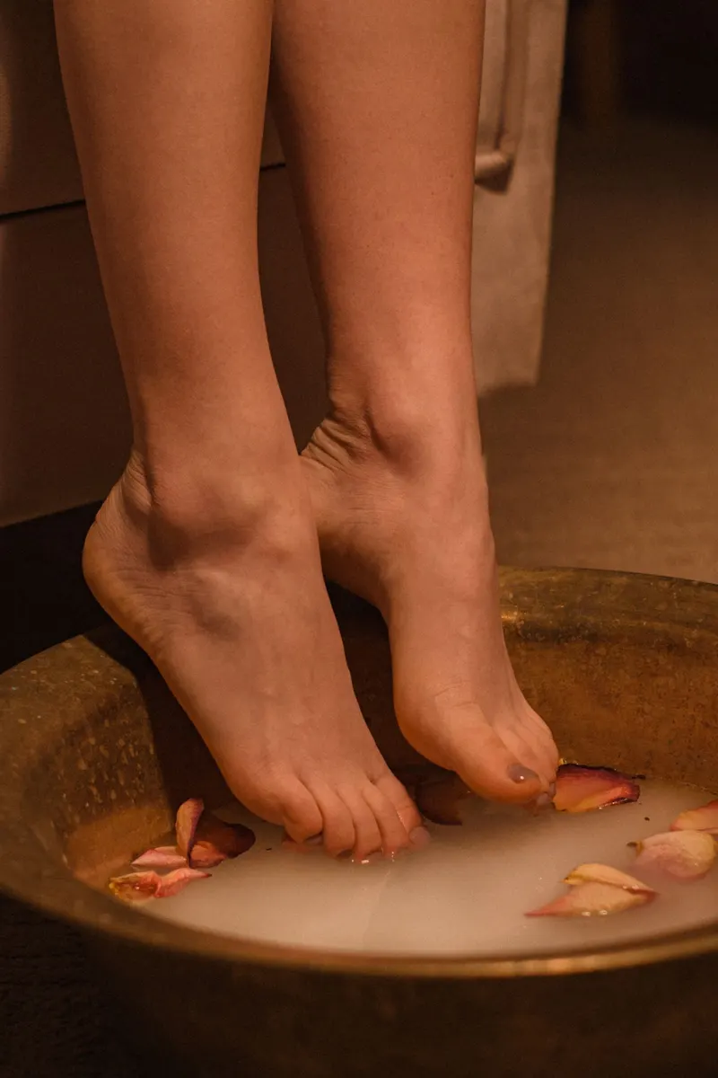 Feet relaxing in a flower-petal foot soak