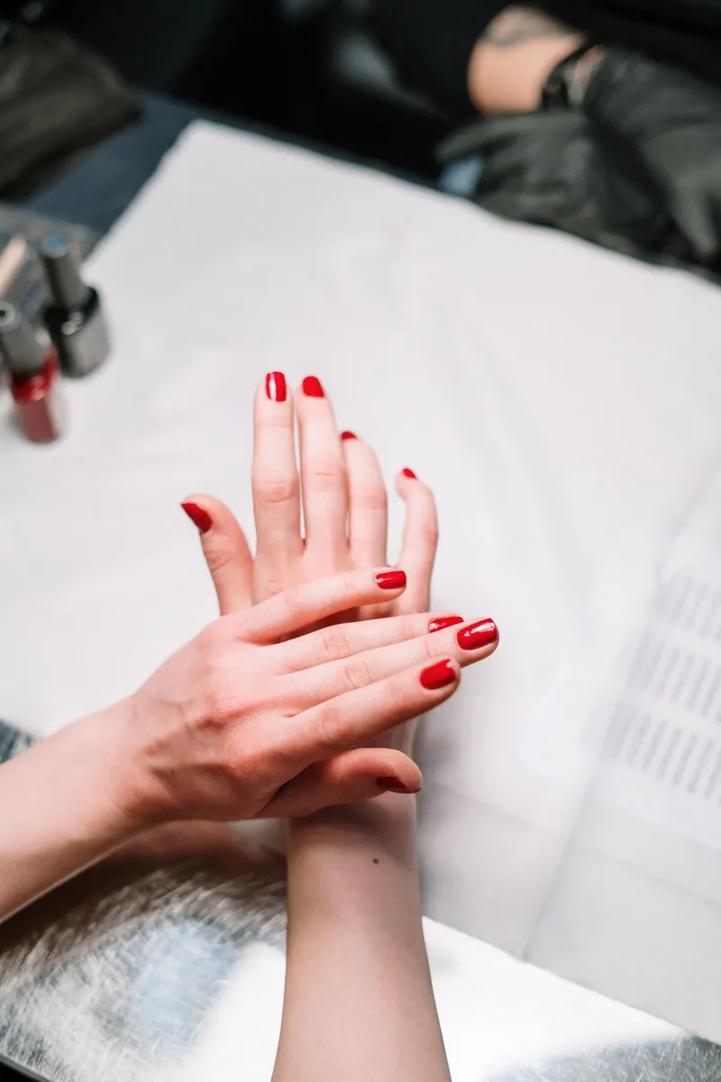 Hands with a glossy red manicure